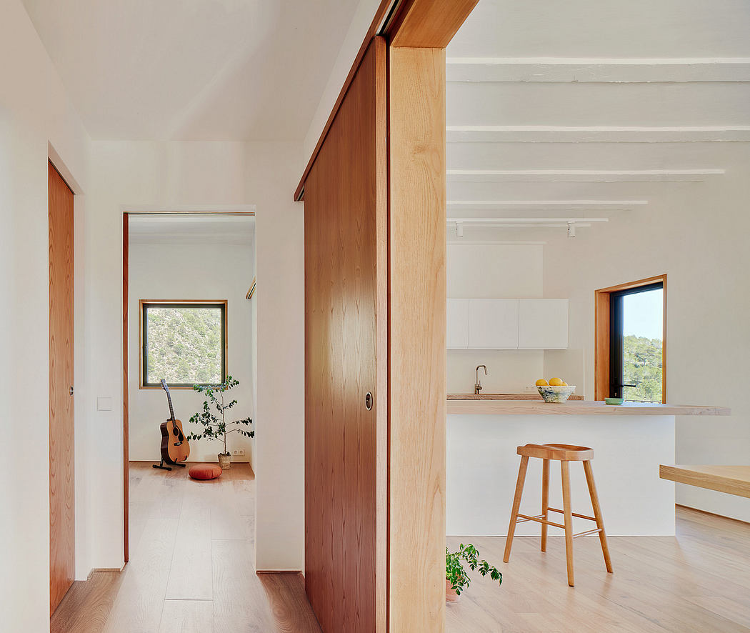 Bright, modern interior with wood accents, open kitchen, and natural lighting.