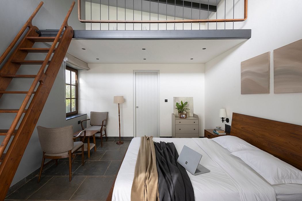 Cozy bedroom with wooden beams, ladder, and natural stone flooring creating a rustic vibe.