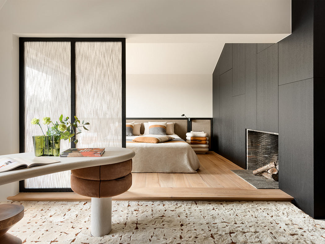 Spacious modern bedroom with minimalist furniture, wooden flooring, and curtain-covered windows.