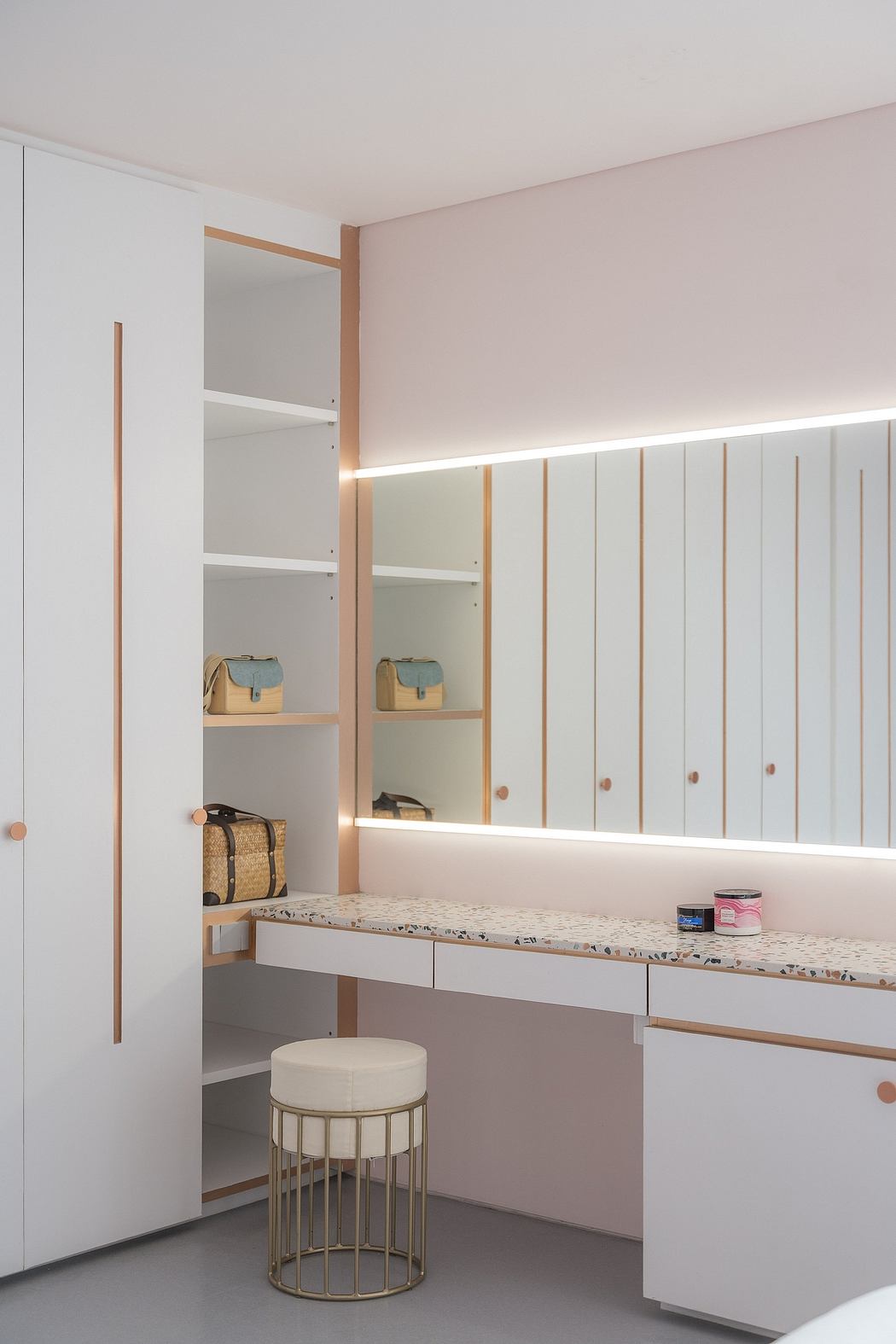 Minimalist, well-designed walk-in closet with ample storage and lighting features.