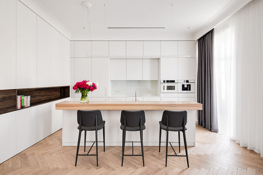 A minimalist kitchen with sleek cabinets, wooden countertop, and built-in appliances.
