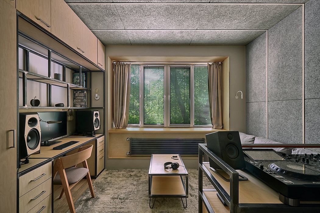 A modern home office with built-in shelving, audio equipment, and large windows overlooking greenery.