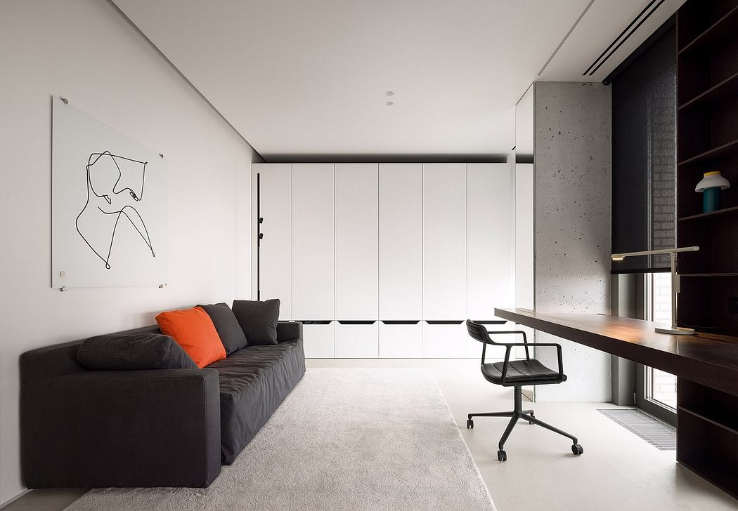 Contemporary apartment with minimalist design, featuring sleek furniture, wall art, and an integrated workspace.