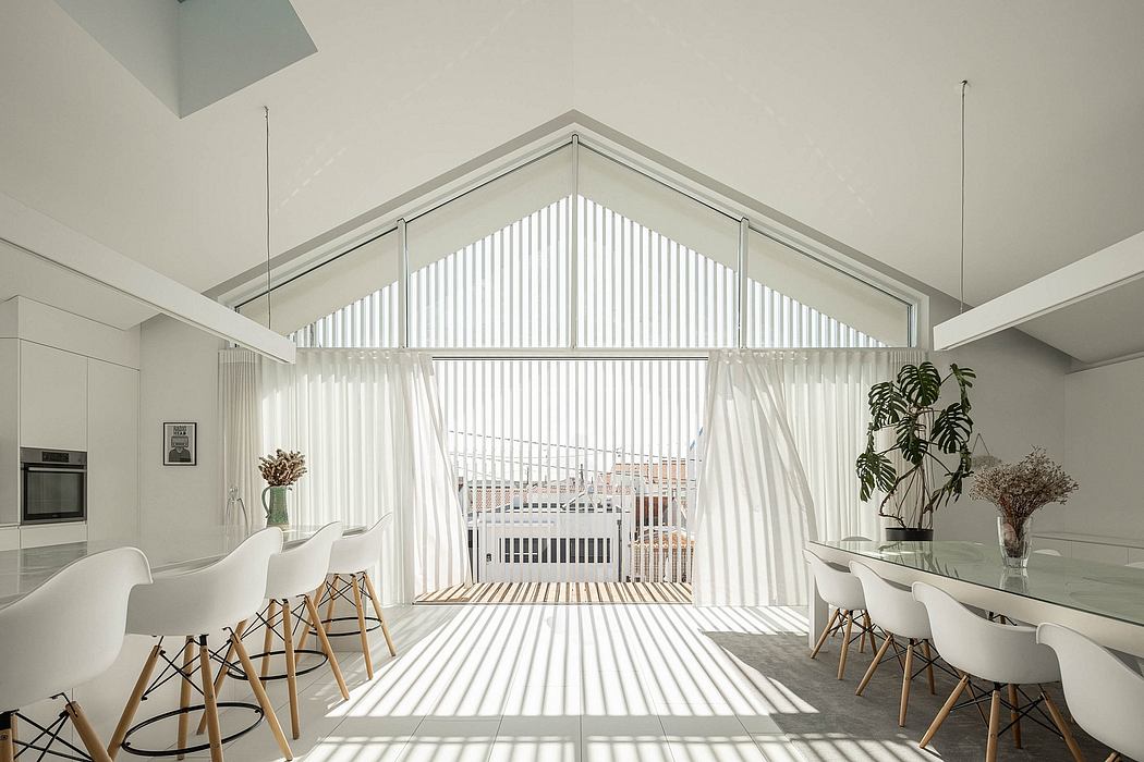 A modern, minimalist interior with tall ceilings, large windows, and sleek furnishings.