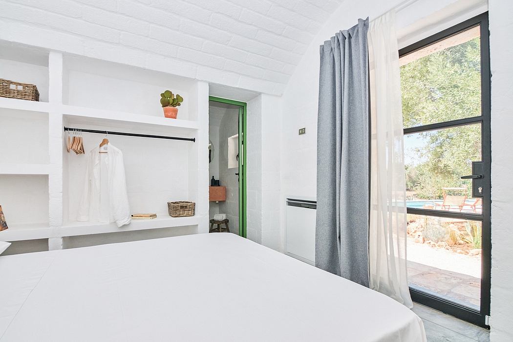 Minimalist bedroom design with built-in shelving, curtains, and sliding glass door.
