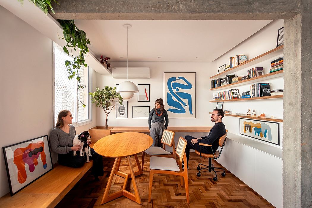Modern, open-plan interior with exposed concrete ceiling, wood furnishings, and vibrant artwork.