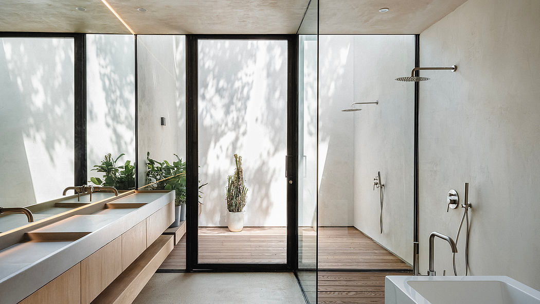 Spacious bathroom with glass walls, wooden floors, and modern fixtures.
