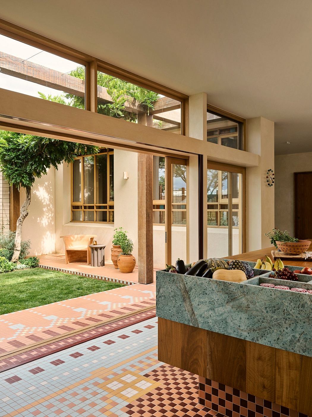 Vibrant mosaic tiles, wooden frames, and lush greenery create a harmonious indoor-outdoor space.
