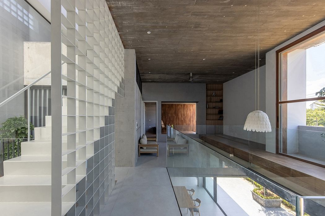 Sleek, modern interior with textured concrete walls, wooden accents, and a glass-enclosed water feature.