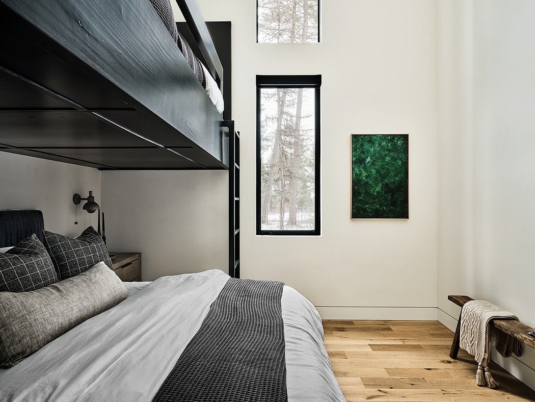 Minimalist bedroom design with high ceilings, large window, and nature-inspired artwork.