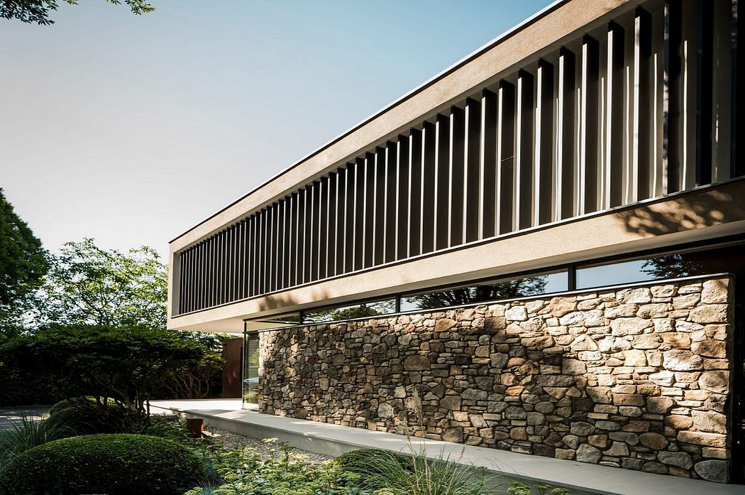 A modern building featuring a stone base and a cantilevered, slatted roof structure.