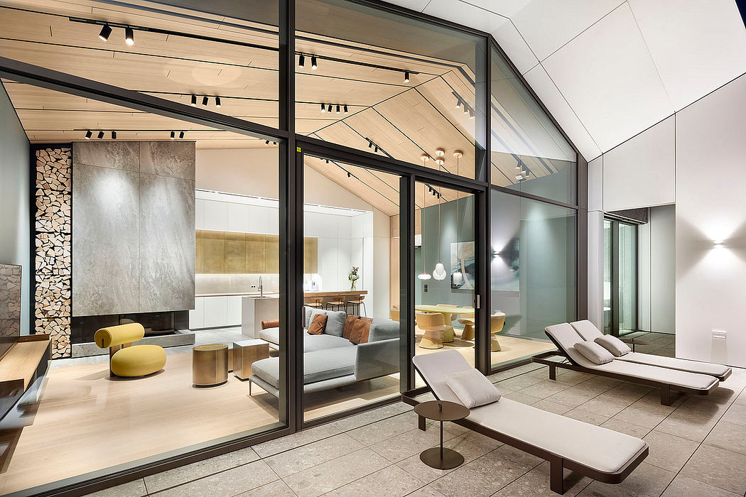 Spacious modern interior with geometric glass walls, wood accents, and plush furnishings.