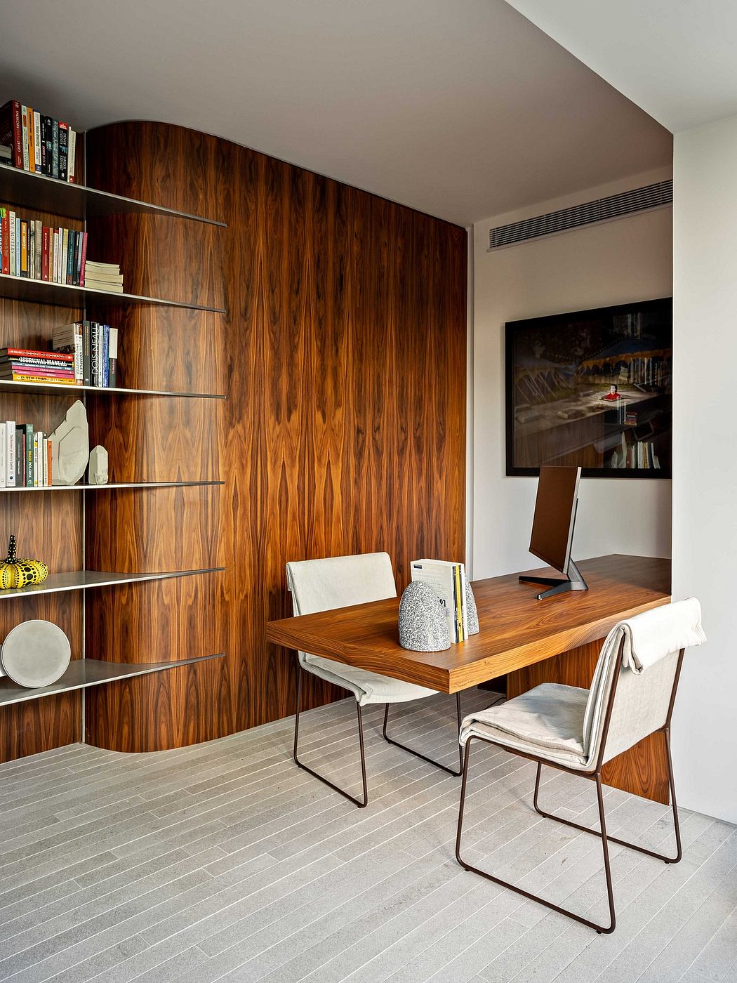 Warm-toned wood paneling, built-in shelves, and a sleek wooden desk create a cozy workspace.