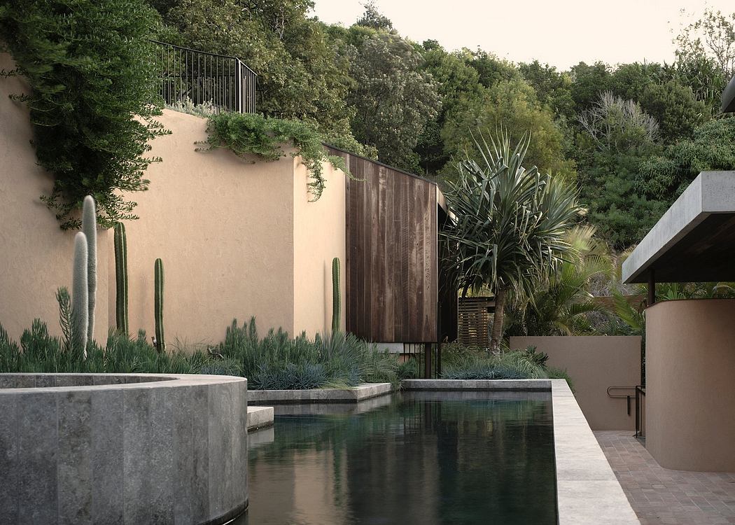 Lush, contemporary garden with rectangular pool, cacti, and wooden fence elements.