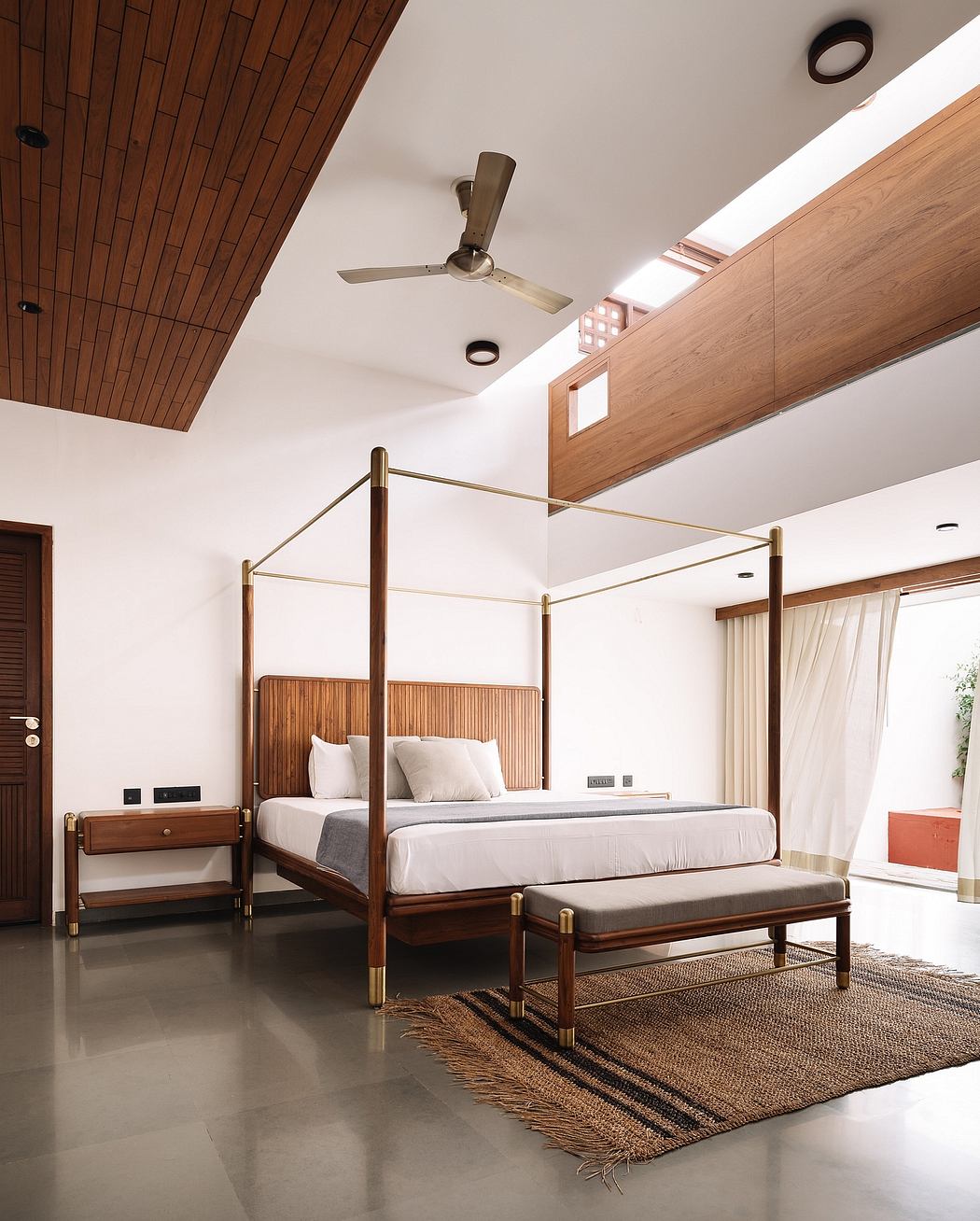 Spacious bedroom with wooden ceiling, sleek furnishings, and modern decor features.
