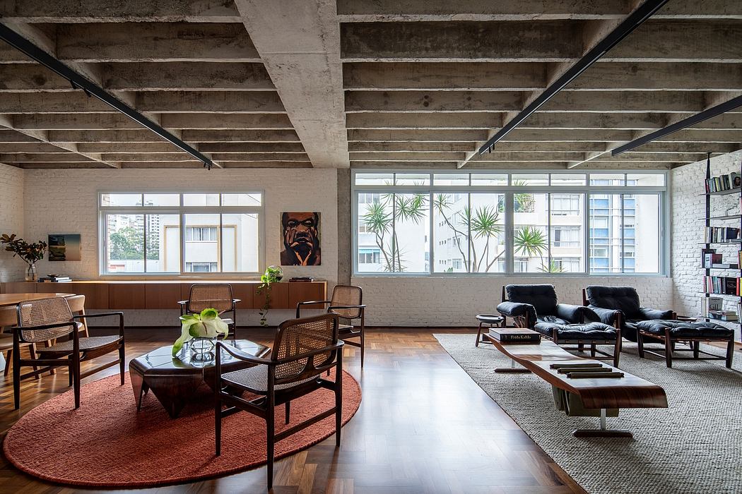 Spacious loft-style living room with exposed concrete ceiling, large windows, and mid-century modern furniture.