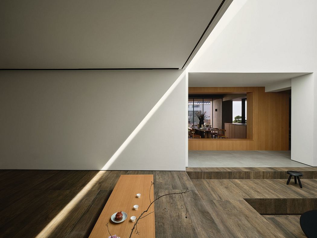 Modern minimalist interior with sleek wood floors, recessed lighting, and open layout.