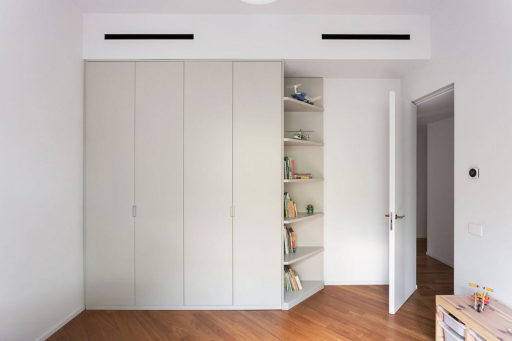 A minimalist bedroom design with built-in closets and shelving for efficient storage.