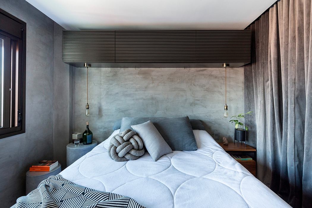 Minimalist bedroom with monochrome color palette, concrete wall, and recessed lighting.