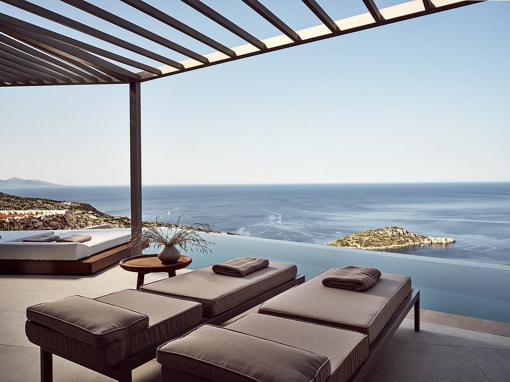 Sleek outdoor lounge with stunning sea views and a modern pergola structure.