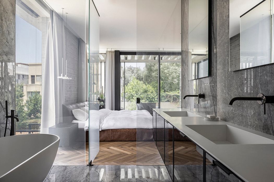 Modern luxury bedroom with marble and glass features, herringbone hardwood floors, and ample natural light.