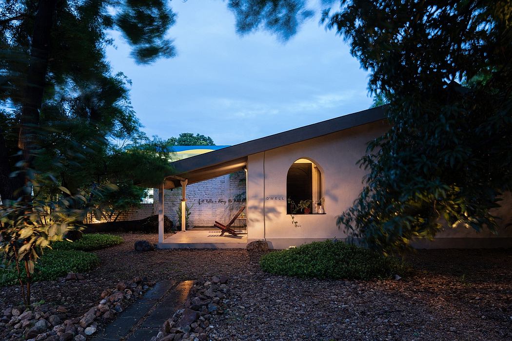 Cozy adobe-style home with arched entryway, sheltered porch, and landscaped grounds.