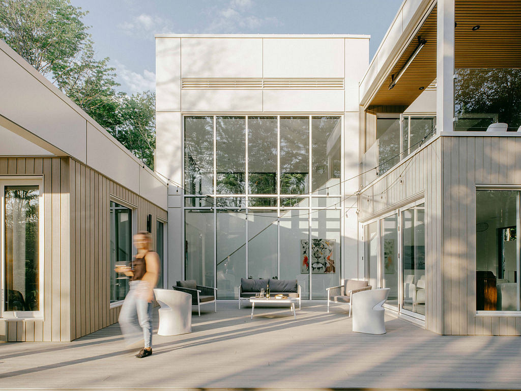 A modern, glass-fronted building with sleek, wooden accents and a minimalist interior design.