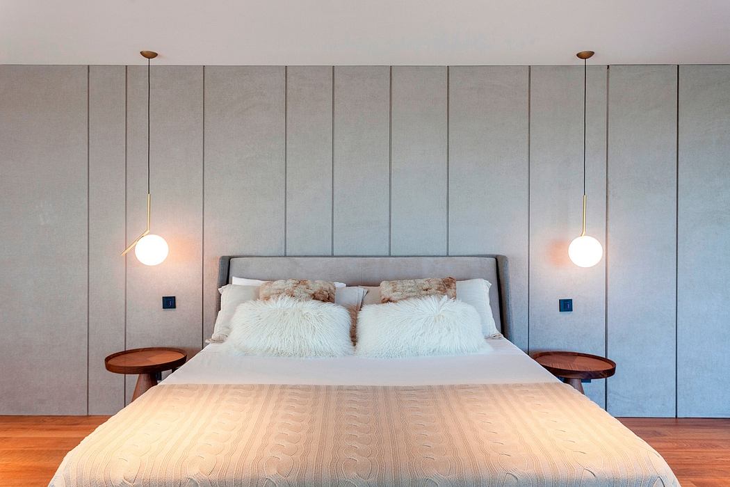 Minimalist bedroom design with wood accents, recessed lighting, and textured wall paneling.