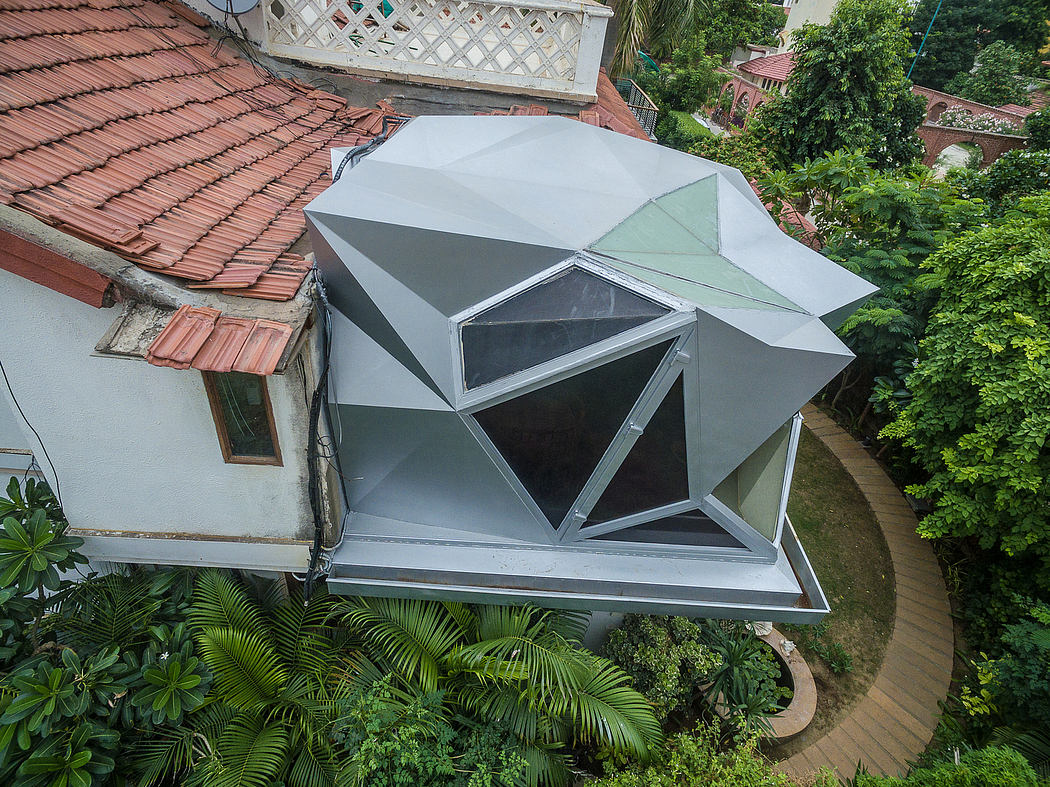 Striking geometric roof structure contrasts with lush tropical surroundings.