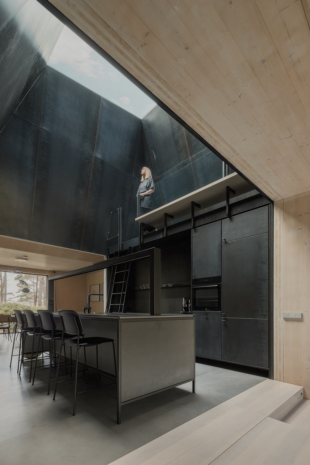 Striking modern kitchen with sleek black cabinetry, high ceilings, and panoramic view.