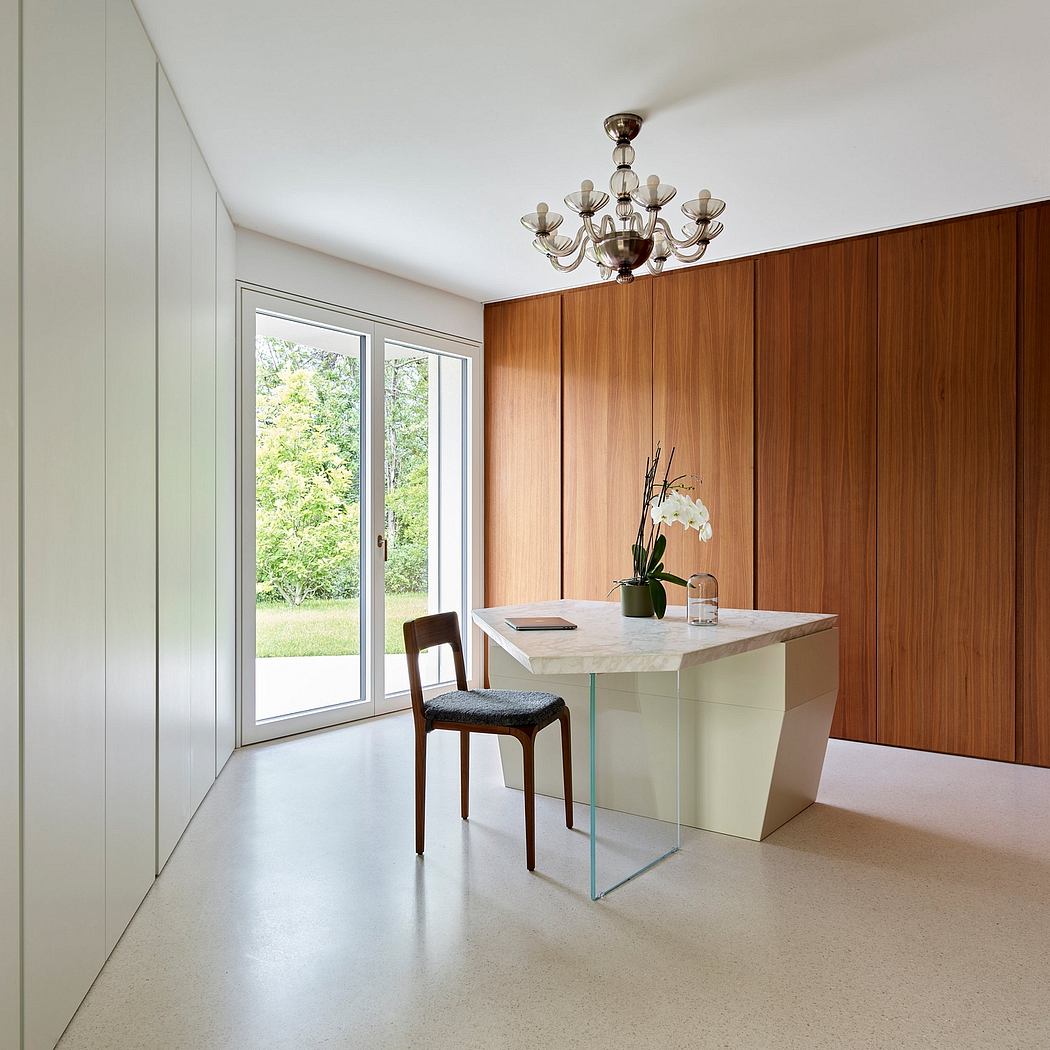 Well-designed dining area with sleek, modern furnishings and a striking chandelier.