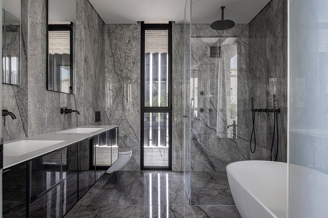 Sleek, modern bathroom with monochrome marble tiles, floor-to-ceiling windows, and minimal fixtures.