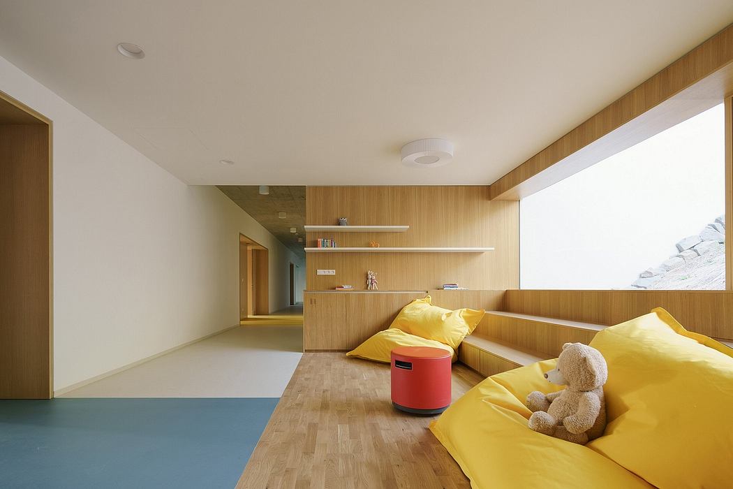 Minimalist interior design with wooden panels, built-in shelves, and vibrant yellow furnishings.