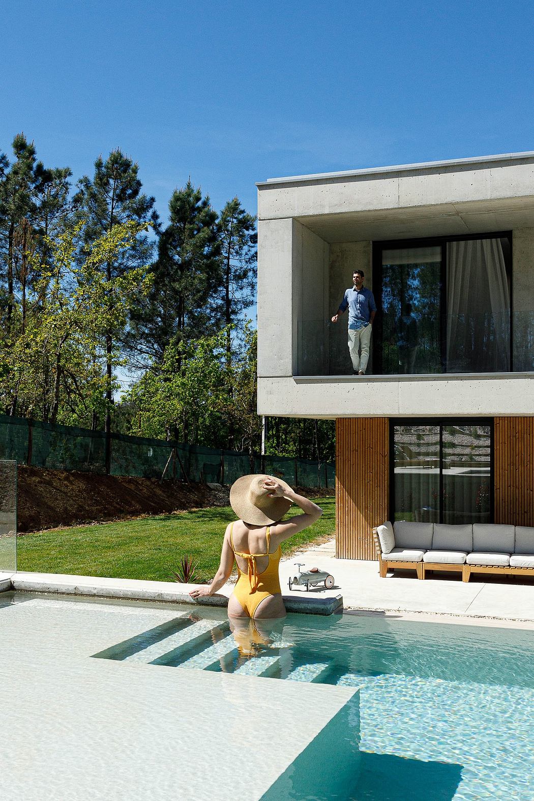 Sleek modern architecture with expansive glass walls and a tranquil pool area.