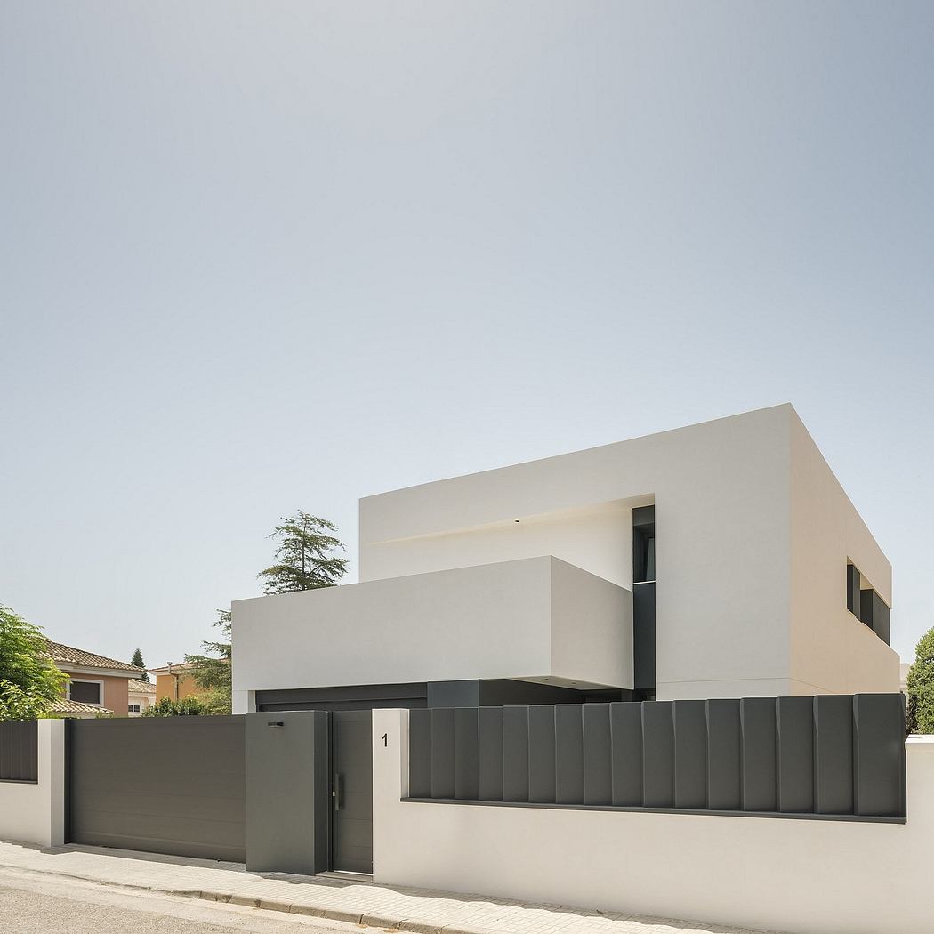 Modern, minimalist residential architecture with clean lines, a cuboid form, and contrasting materials - concrete and light walls.