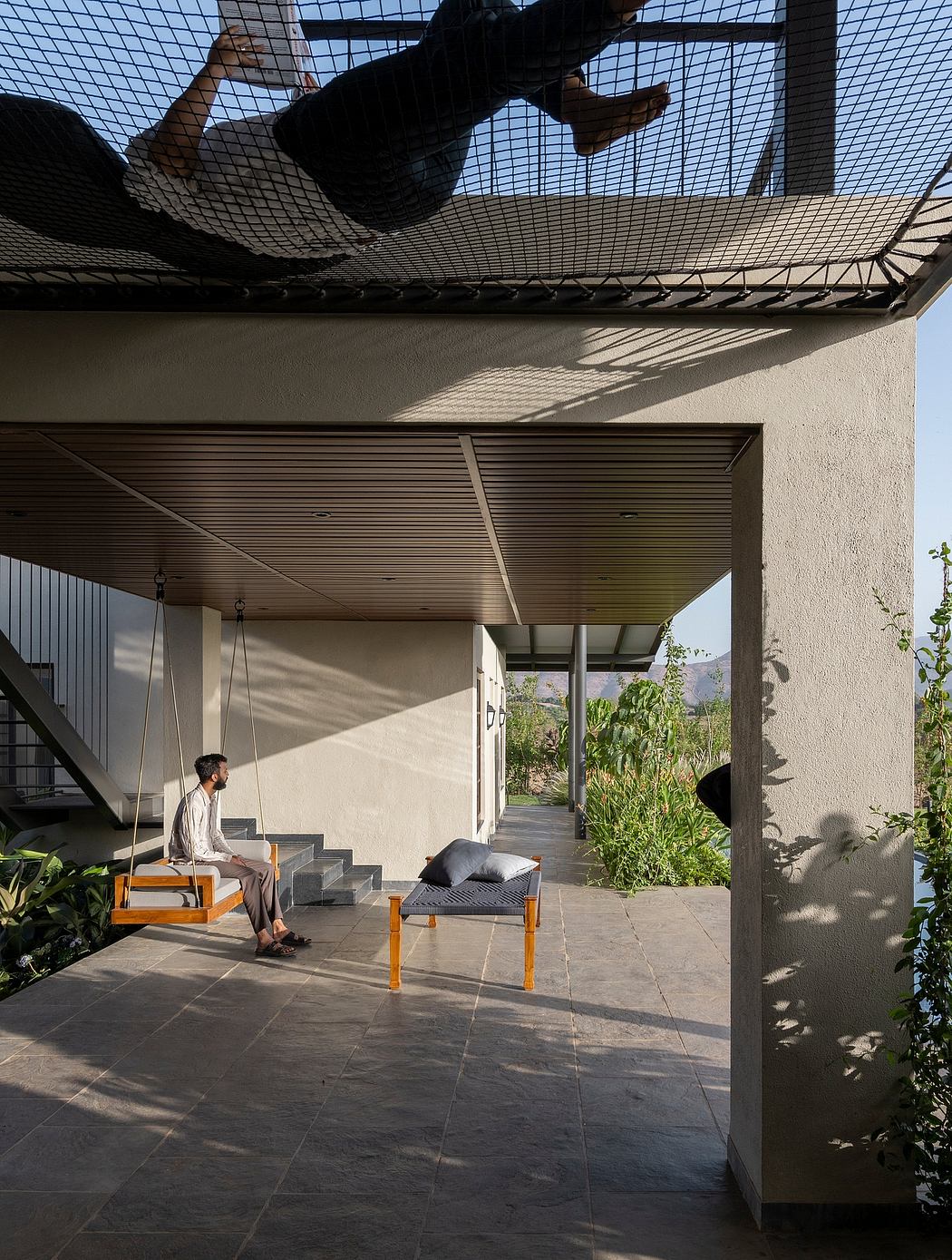 Striking outdoor patio with modern architecture, stone flooring, and seating.
