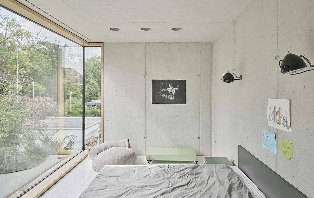 Modern bedroom with concrete walls, large windows, and minimalist furnishings.