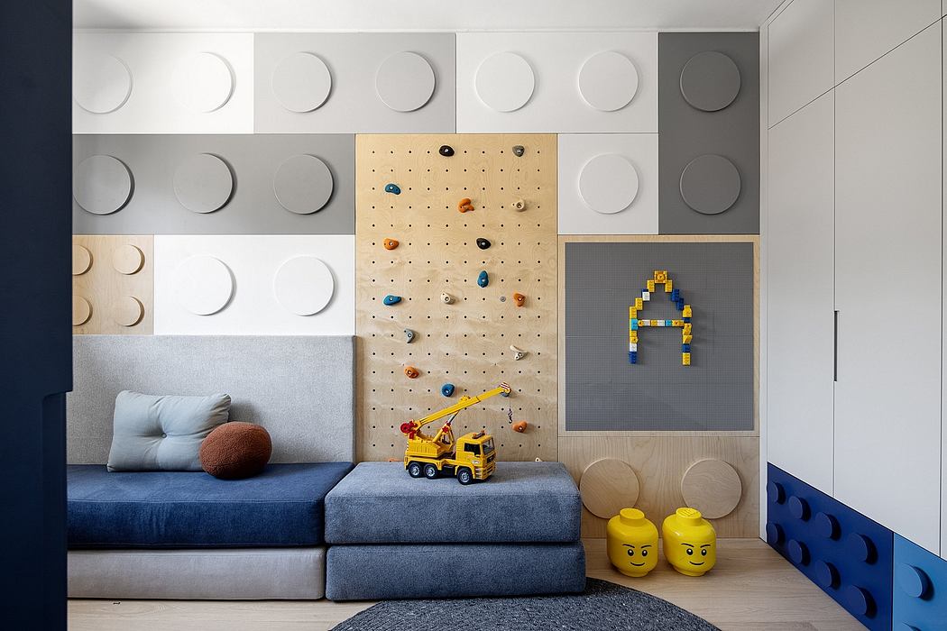 A modern children's room with a climbing wall, storage cubes, and colorful accents.