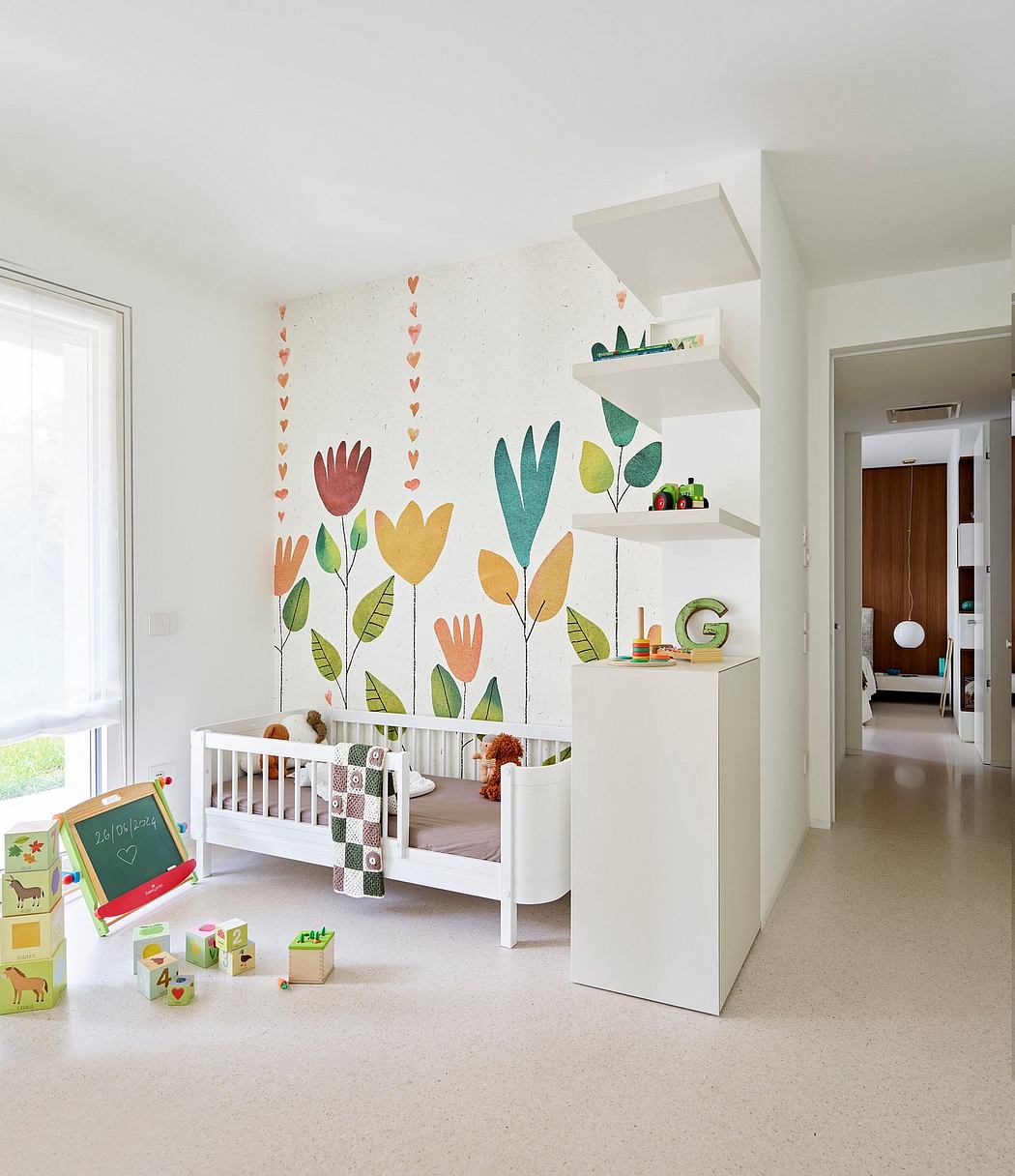 Bright, colorful nursery with whimsical floral mural, white crib, and decorative shelves.
