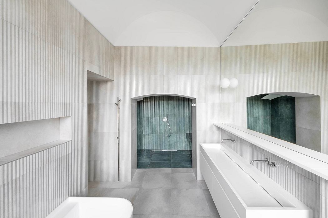 Minimalist bathroom with clean lines, textured walls, and curved glass shower enclosure.
