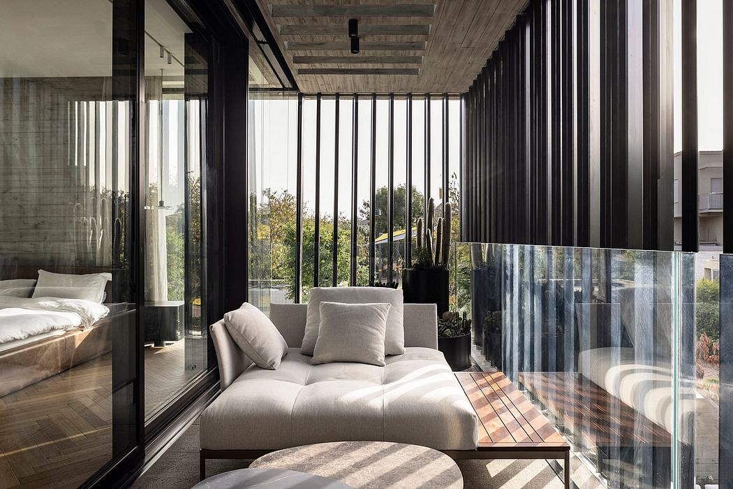 Sleek, modern bedroom with floor-to-ceiling glass walls overlooking lush greenery.