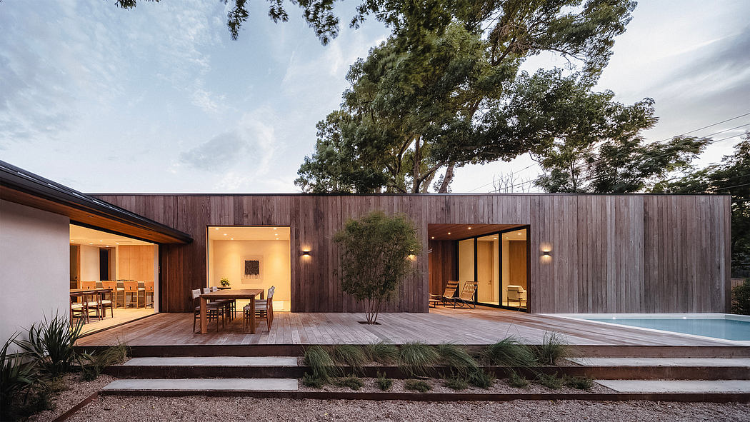 Sleek modern home with wooden exterior, open floor plan, and inviting pool area.