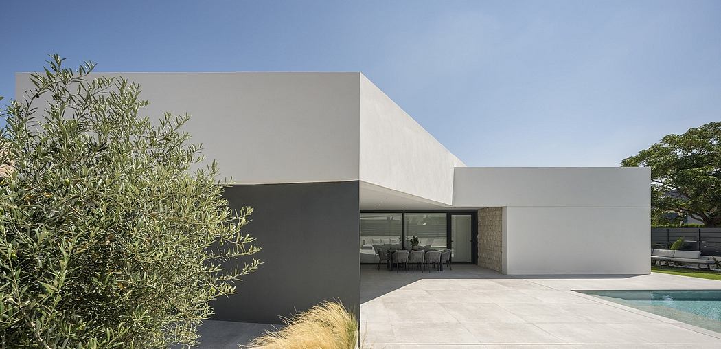 A contemporary two-story home with clean lines, large windows, and a minimalist design.