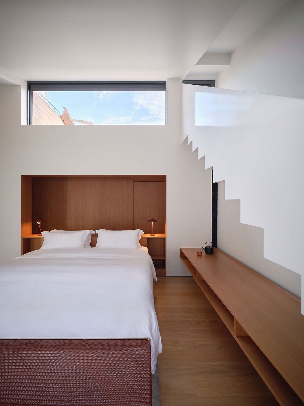Minimalist modern bedroom with wooden furniture, clean lines, and natural lighting.