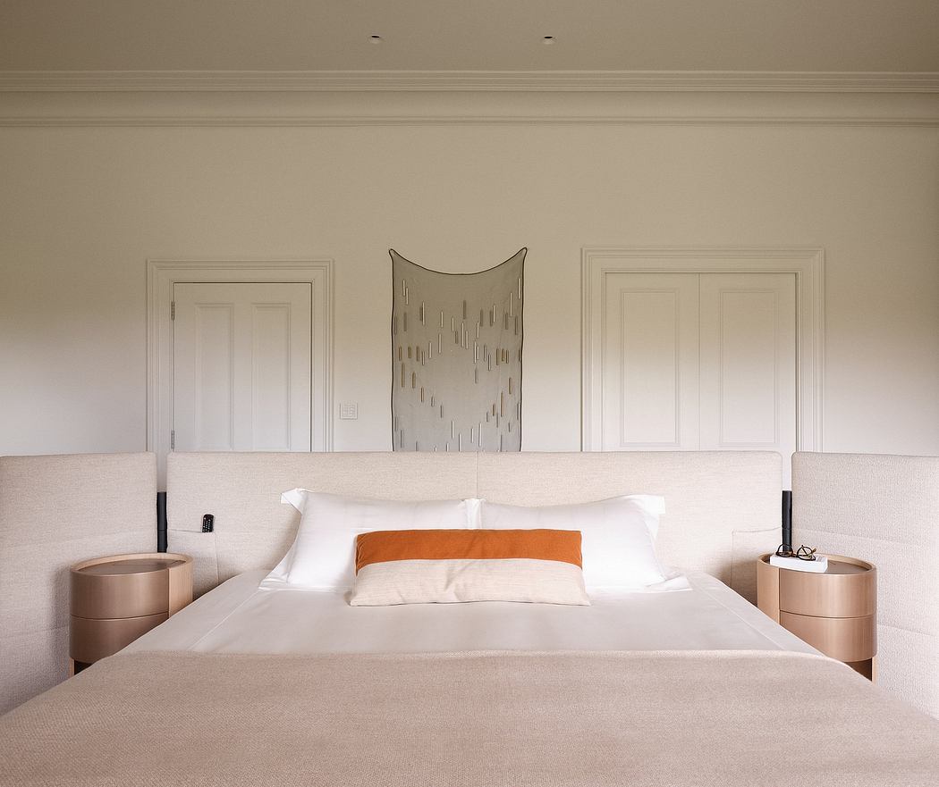 A modern bedroom with elegant architectural details, minimalist furnishings, and a striking sculptural light fixture.