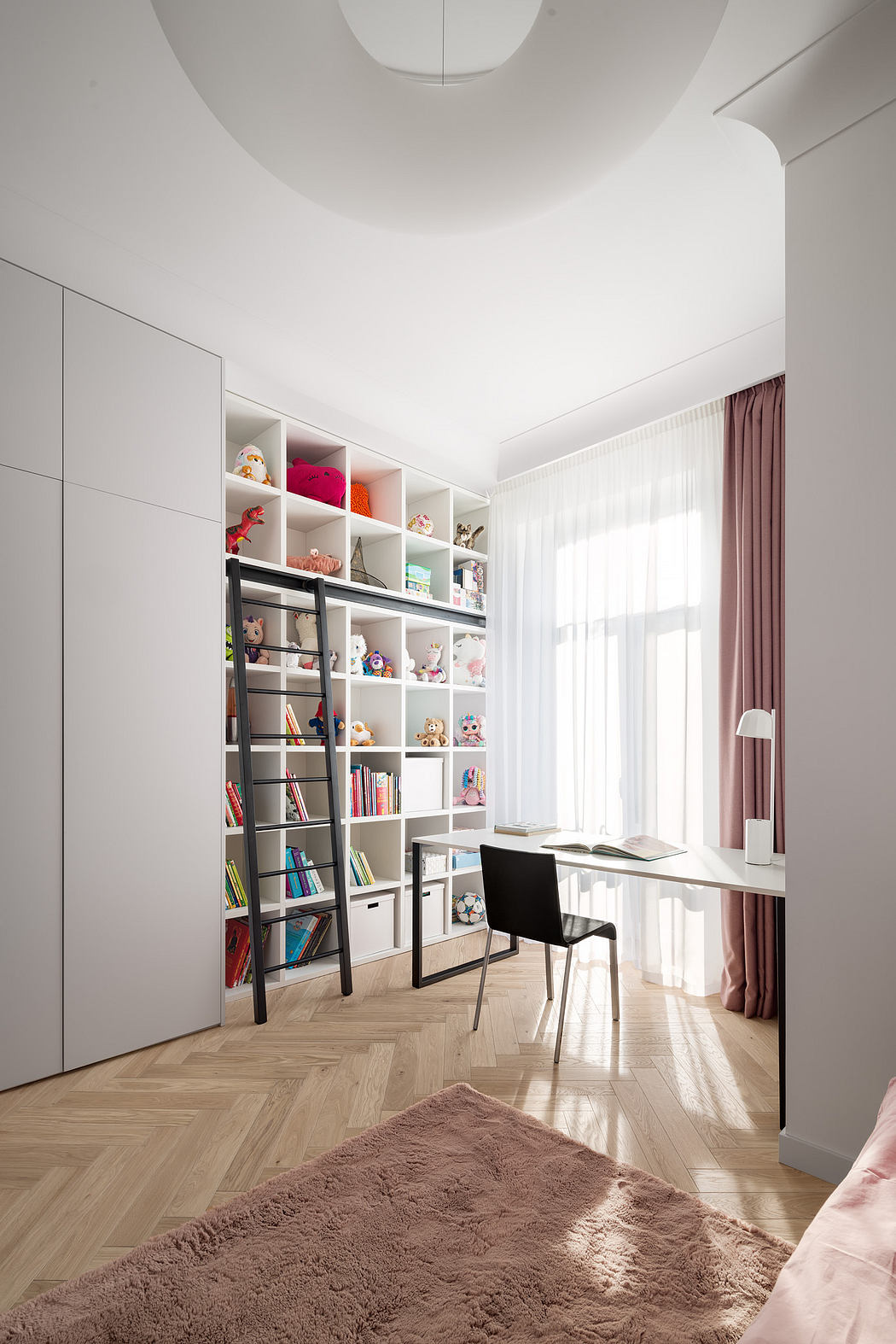 Well-organized shelves and desk in a bright, modern bedroom with herringbone flooring.