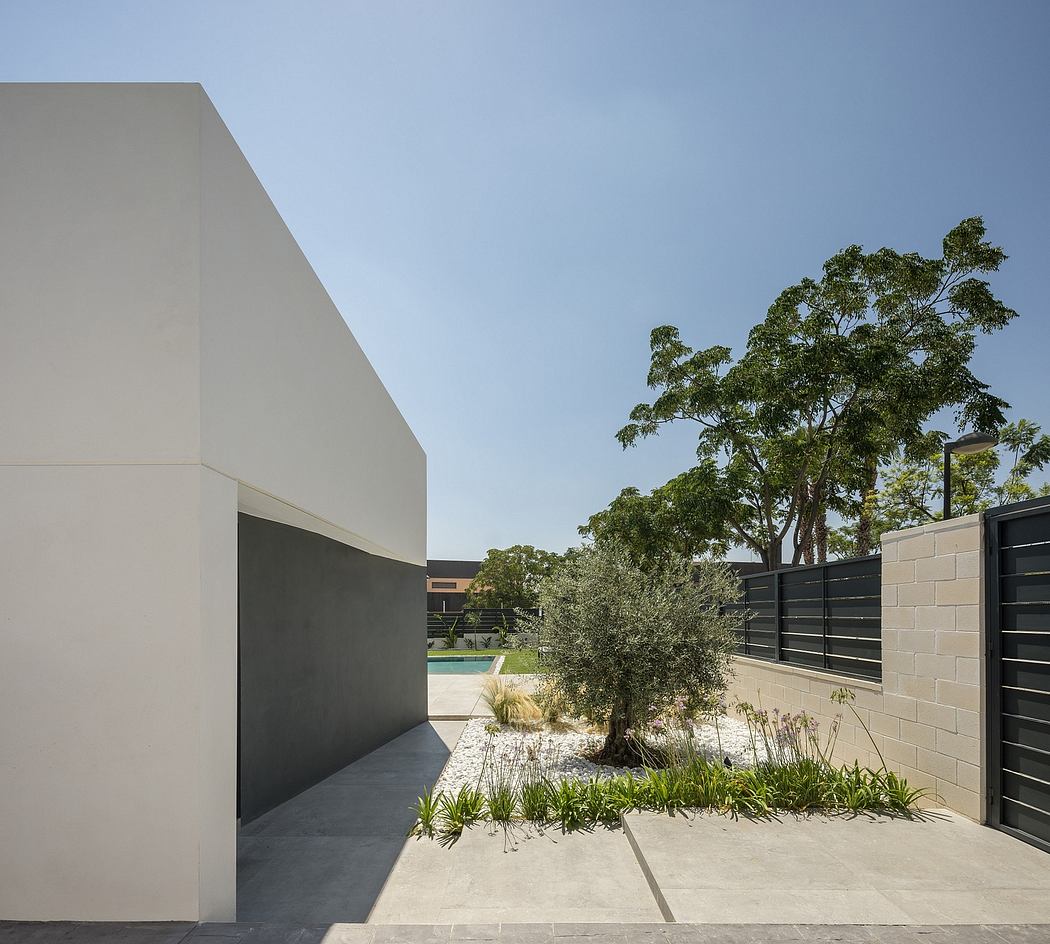 Minimalist architecture, clean lines, and lush greenery create a serene outdoor space.