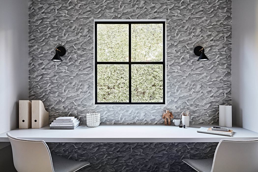 Minimalist workspace with textured gray walls, large window, and simple decor elements.