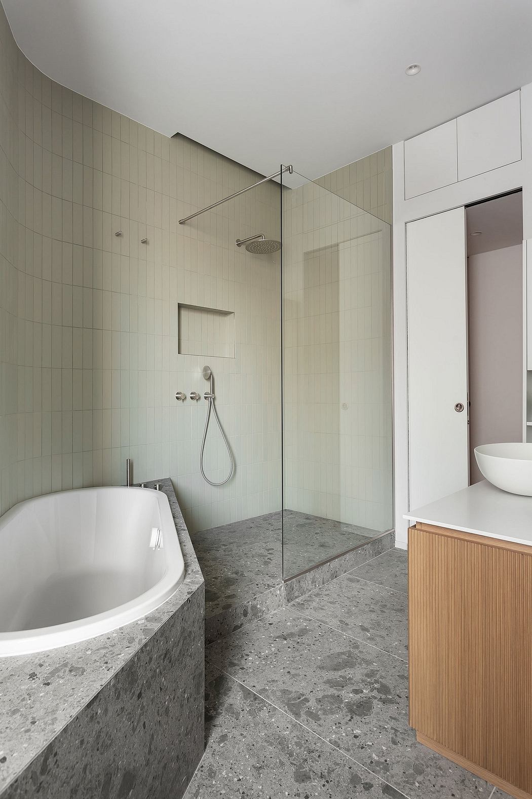 A modern bathroom with a stylish bathtub, minimalist shower enclosure, and sleek vanity.