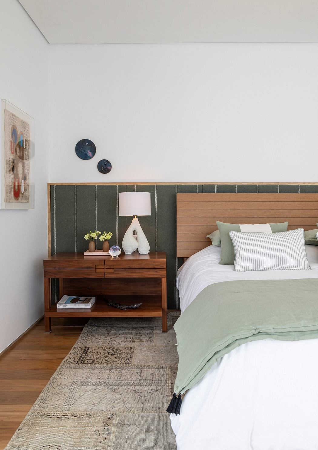 Cozy bedroom with wooden furniture, textured wall panels, and decorative accents.